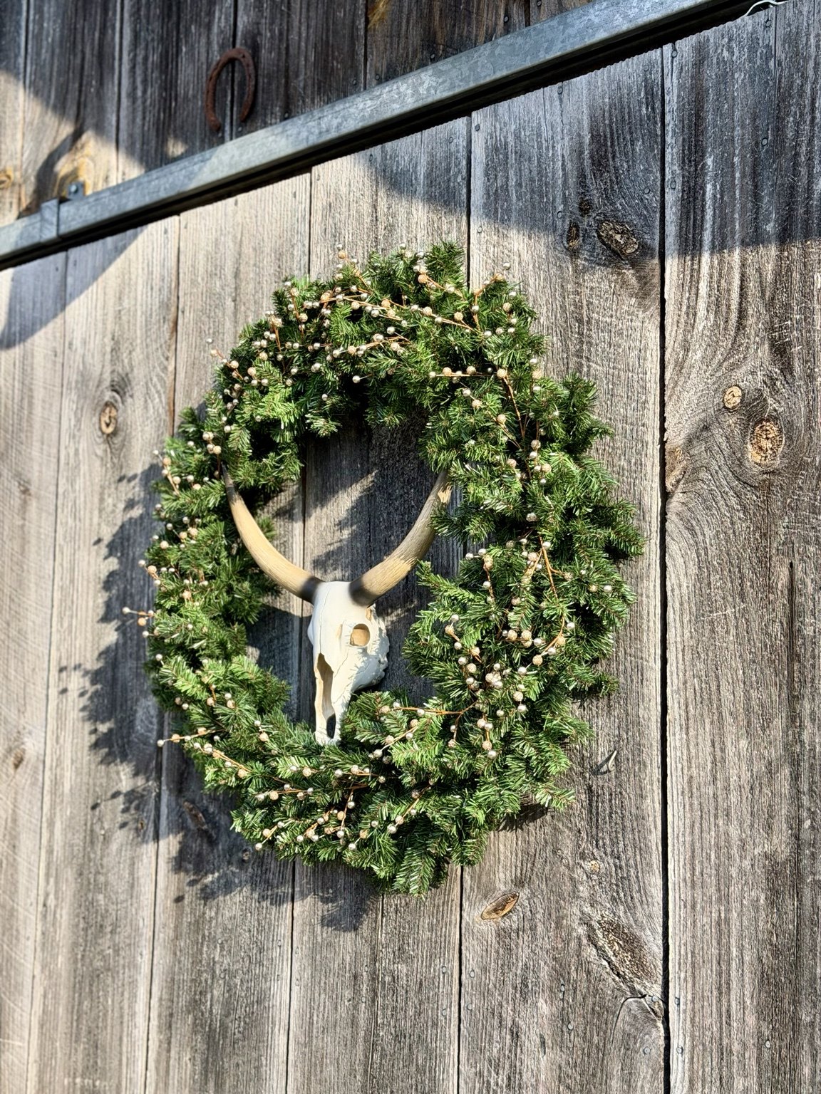 Evergreen wreath on the weathered barn