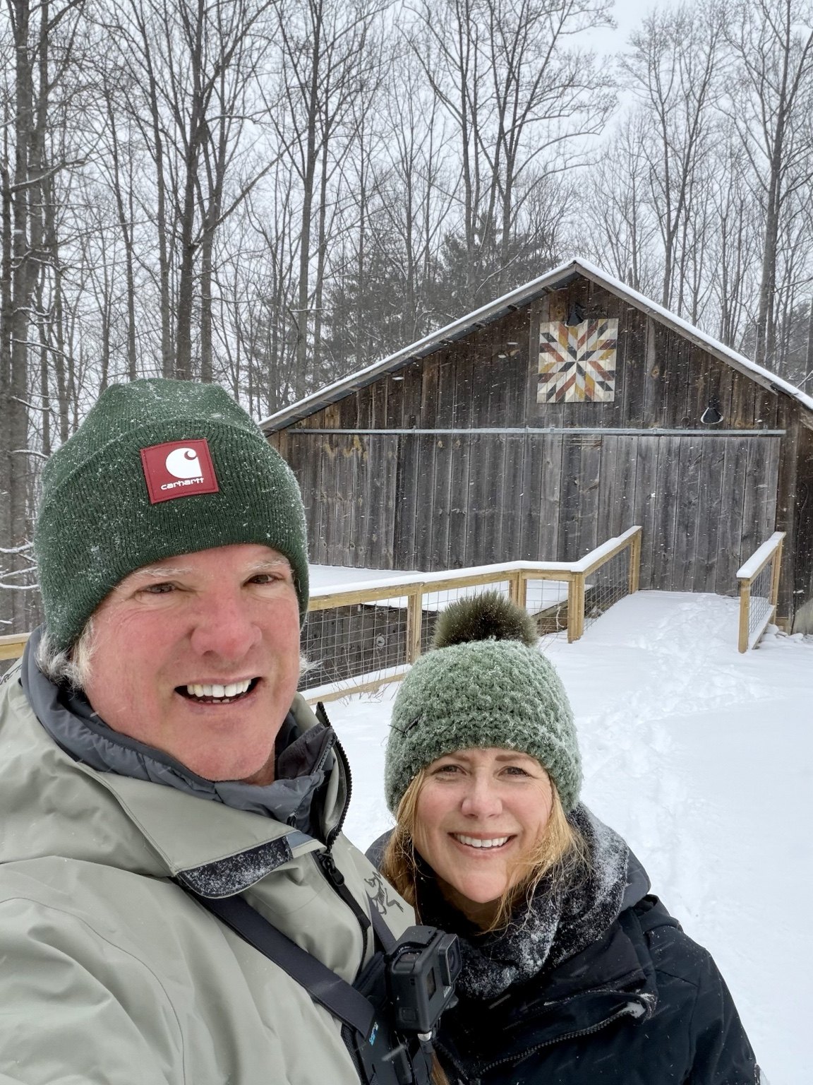 Barry and Angele together in the snow outside their barn